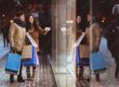 Couple window shopping holding shopping bags in winter